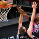 Miami Heat center Bam Adebayo dunks over San Antonio Spurs center Jakob Poeltl during the second half last night.